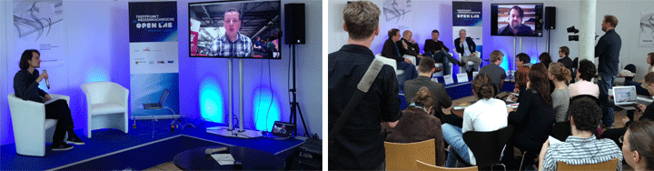 Hybrid-Event an der TUM: Bühne mit Remote-Sprecher auf LED-Screen, Live-Panel und Publikum bei Open Lab in München