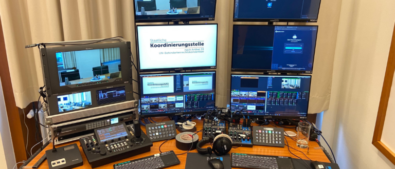 Professionelle Streaming-Regie mit Monitorwand und Steuerpulten für barrierefreie Livestreams der Staatlichen Koordinierungsstelle